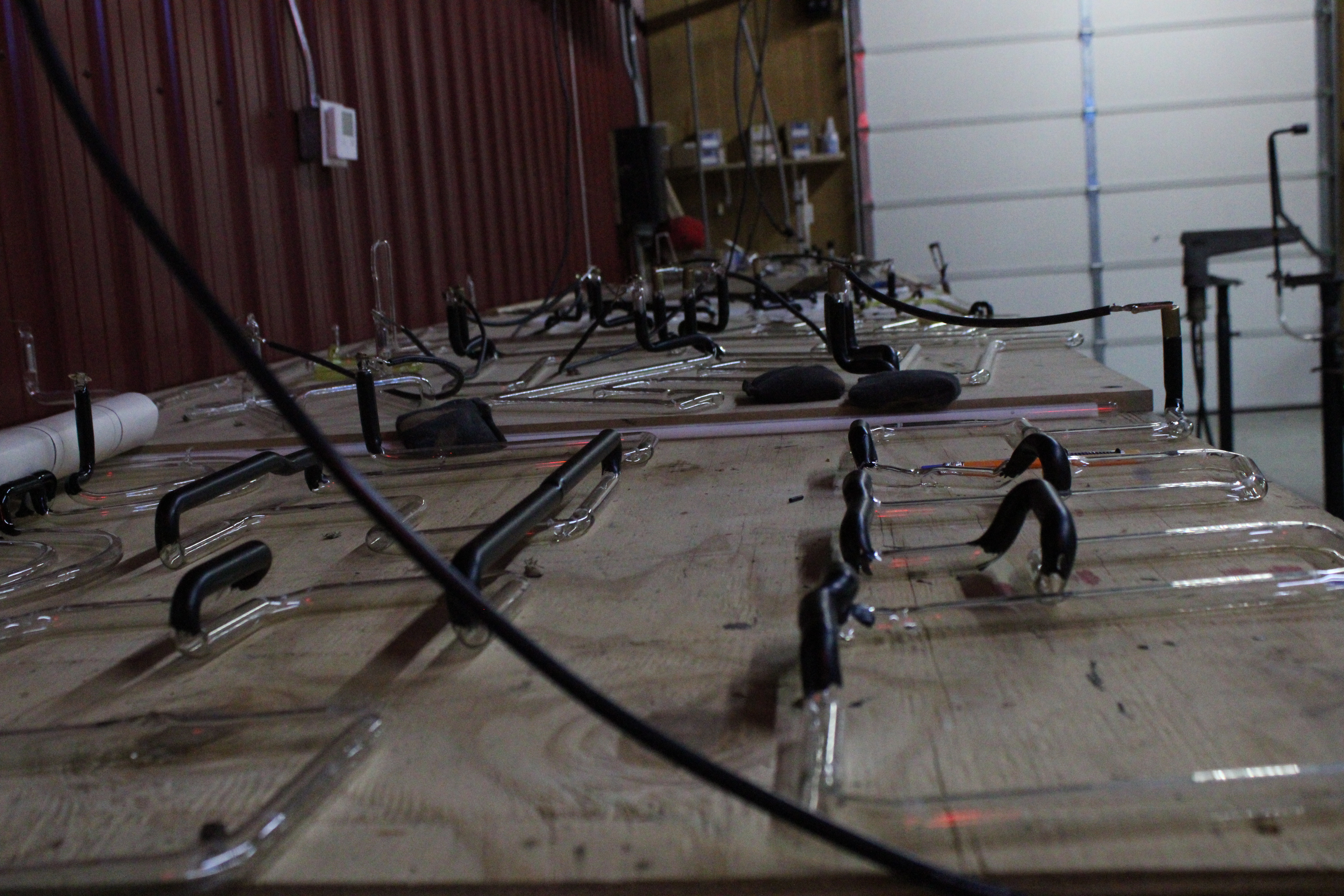 Glass neon tubes laid out in the shop