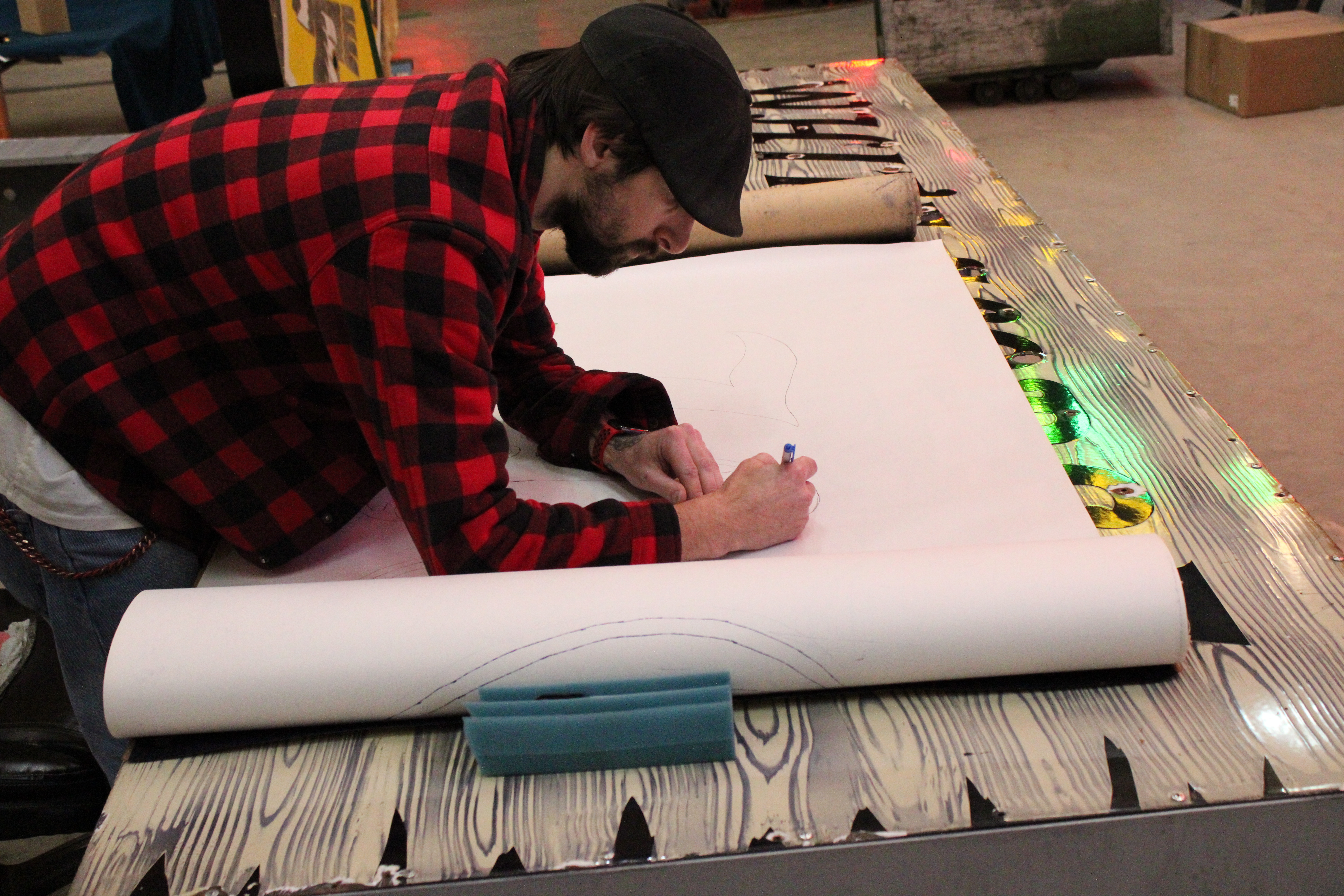 Artisan drawing neon sign pattern by hand
